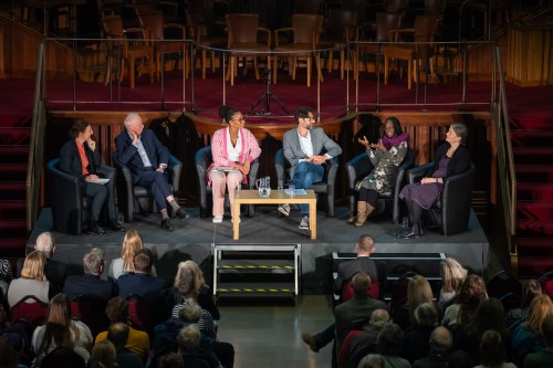 6 people sat on a stage